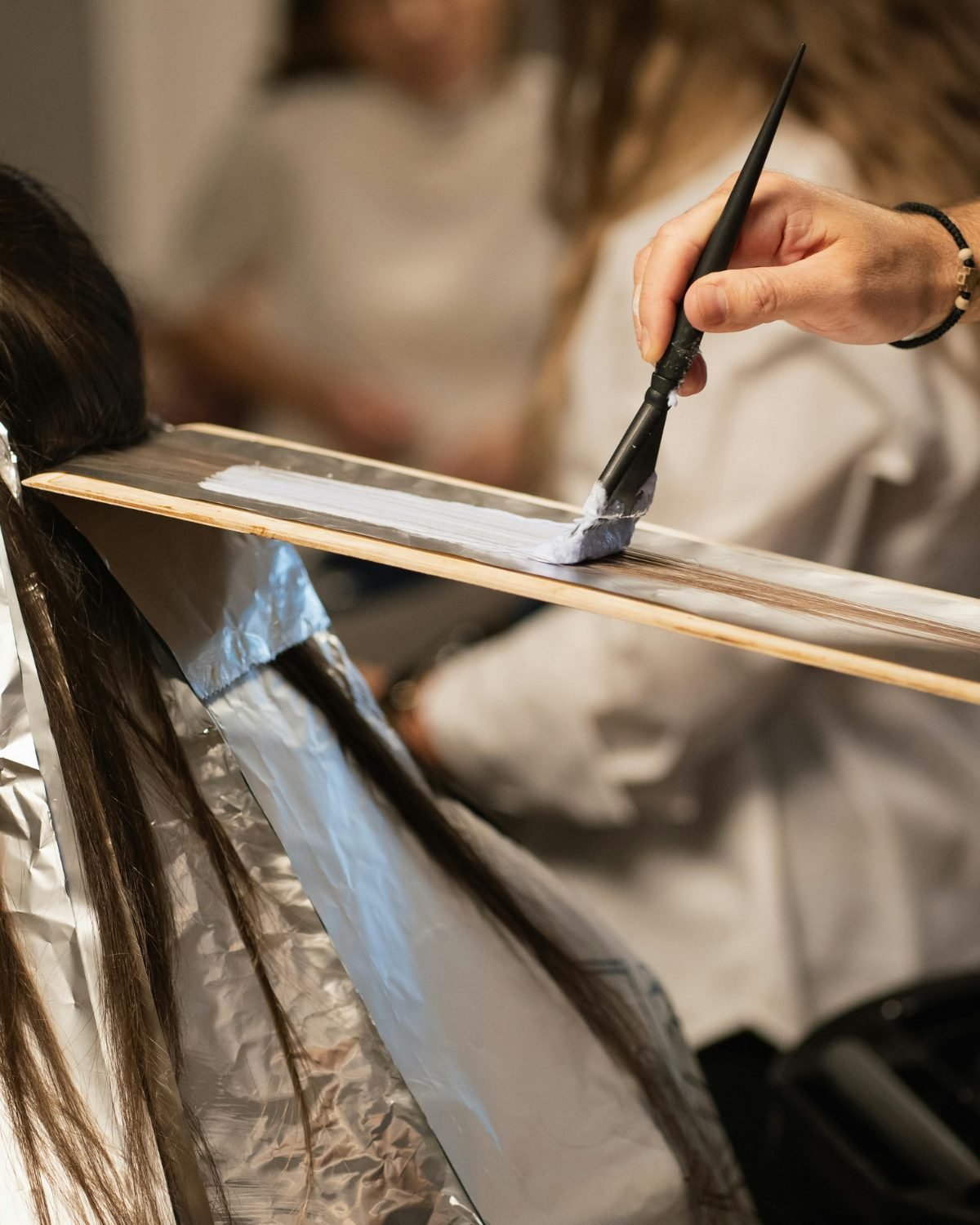 Hair colour foils being applied at Crystal Scissori